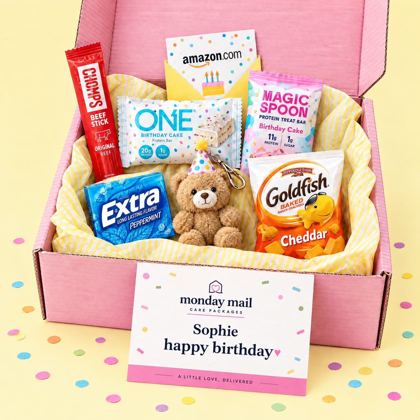 The pink Birthday box with birthday-cake snacks, a party-hat plush bear, an Amazon gift card and a Happy Birthday card