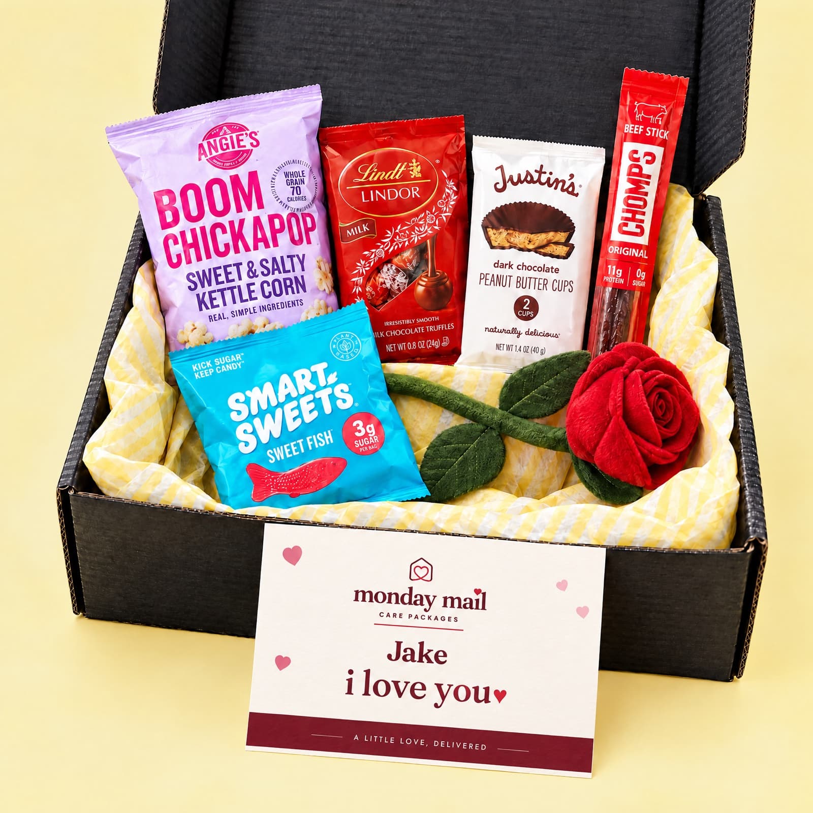 The black Love box with kettle corn, Lindt truffles, peanut butter cups, SmartSweets, a plush rose and an I Love You card